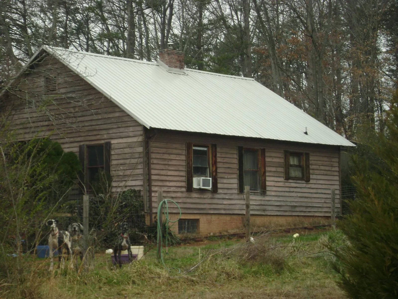 White metal roof on an old wood sided farmhouse, from a Metal Roof Installation job in Glade Hill